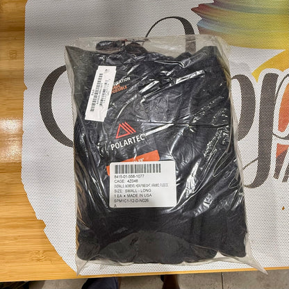 Packaged black gloves with Polartec branding on a colorful background