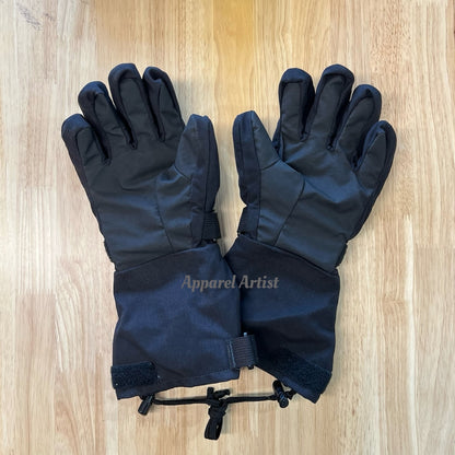 Pair of black gloves on a wooden surface with 'Apparel Artist' branding.